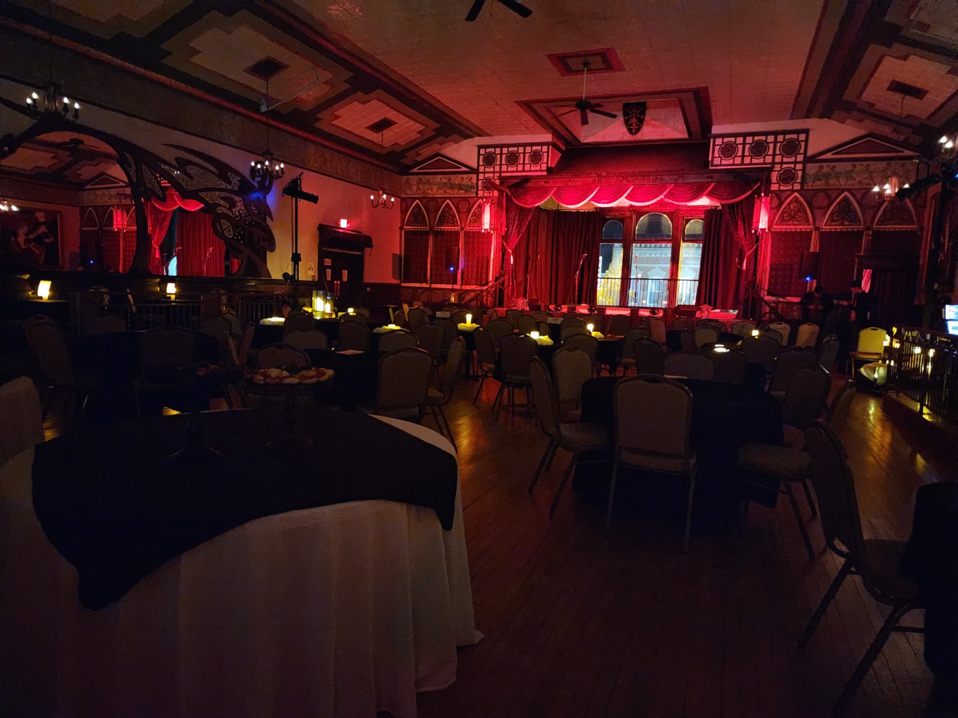 The Rooted Gypsy Repertoire theater hall, warm stage lights glowing over the audience